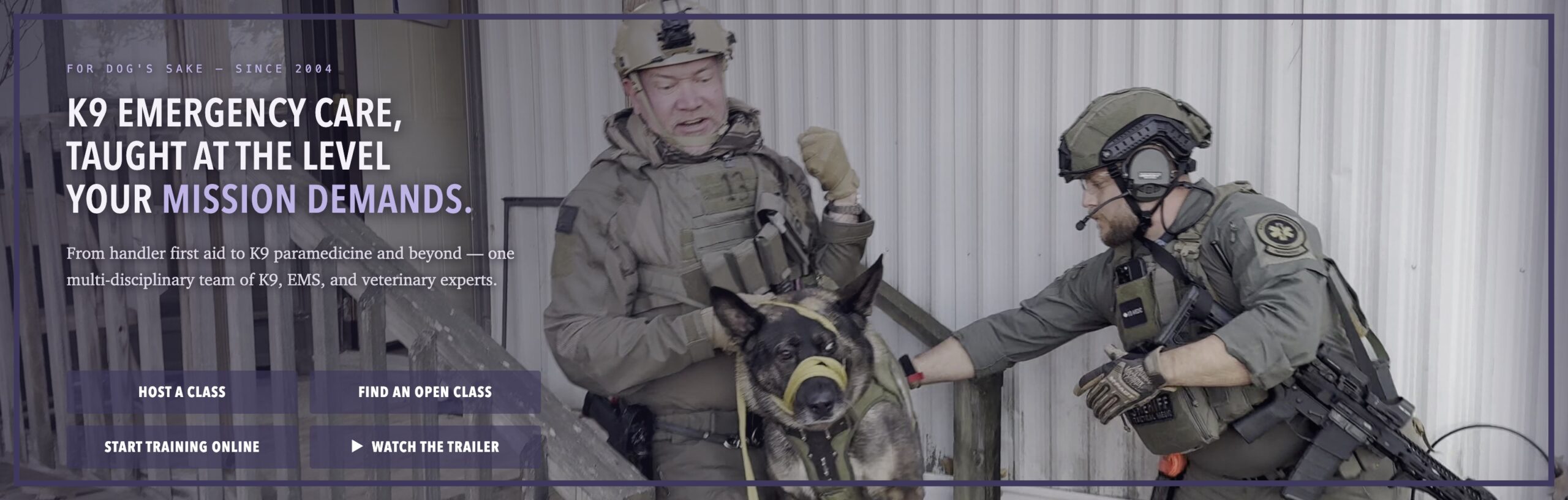 Two K9 MEDIC operators carry a muzzled German shepherd down porch steps during a training scenario